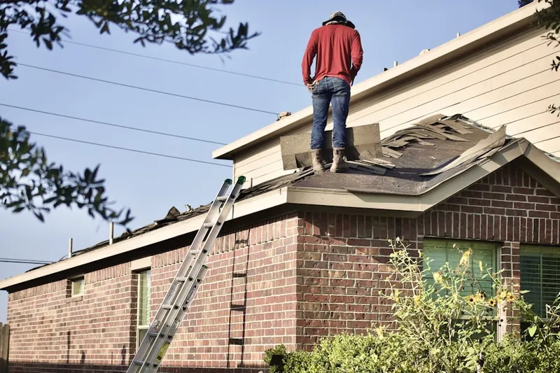Professional roofer working on a residential roof in Monterey Orchards